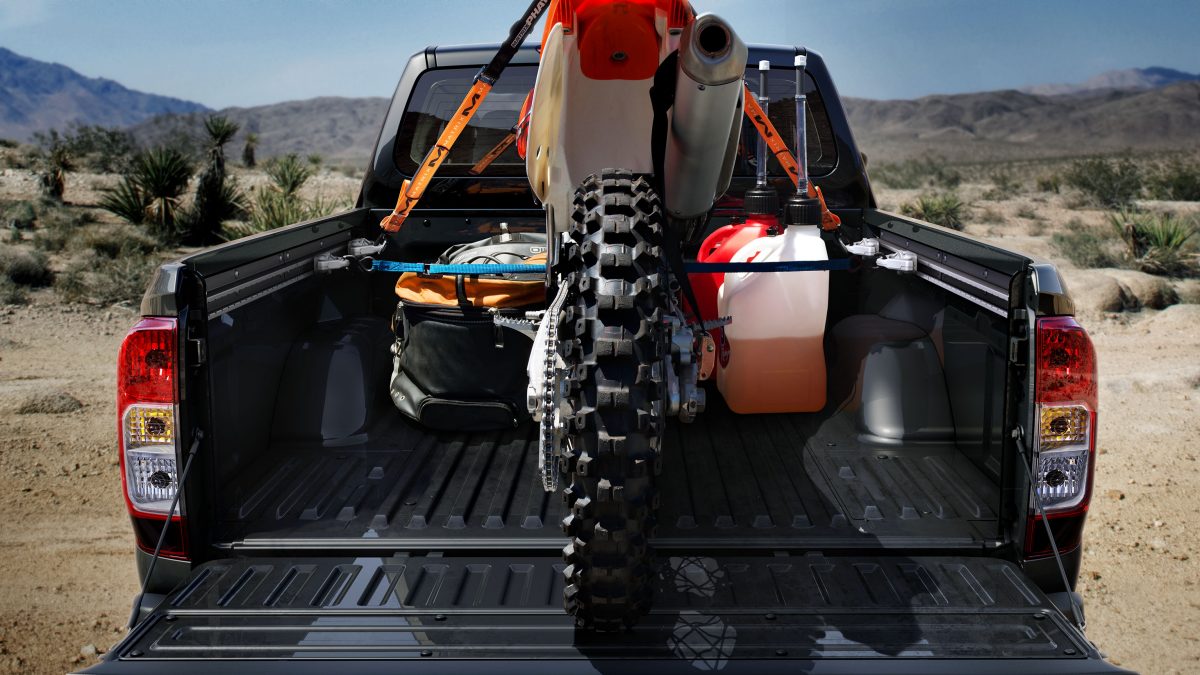 Rear Static Shot of Cargo Bed with Dirt Bike Loaded in Desert